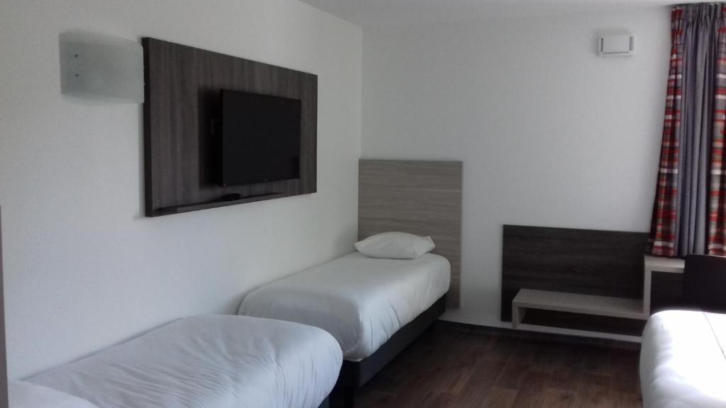 Postel nebo postele na pokoji v ubytování Hotel Arena Toulouse