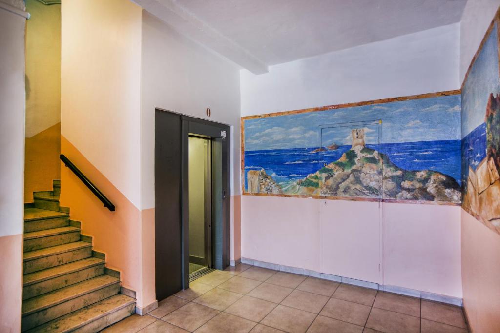 a hallway with stairs and a painting on the wall at Hotel le Dauphin in Ajaccio