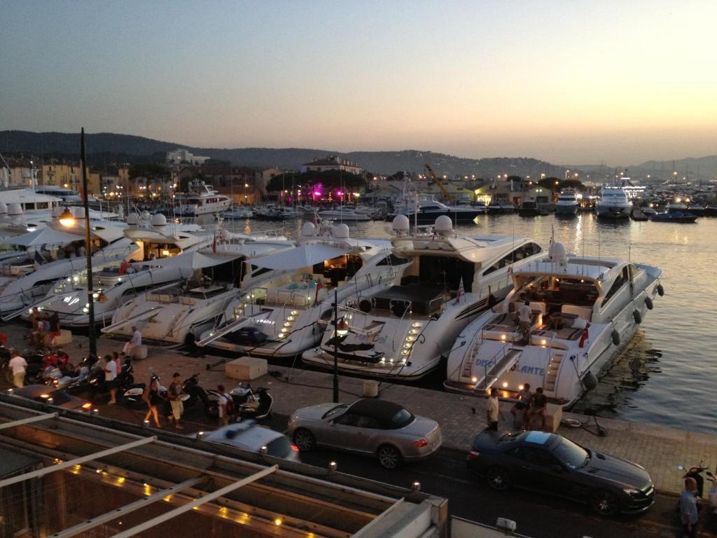 a group of boats docked at a marina at night at Port de Saint-Tropez in Saint-Tropez