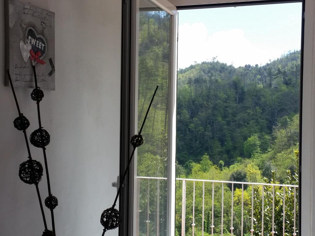 a window in a room with a view of a mountain at B&B La Costa in Pignone