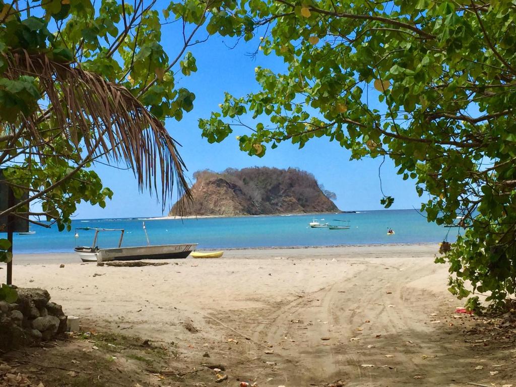 uma vista para uma praia com um barco sobre ela em Cabinas del Mar em Sámara