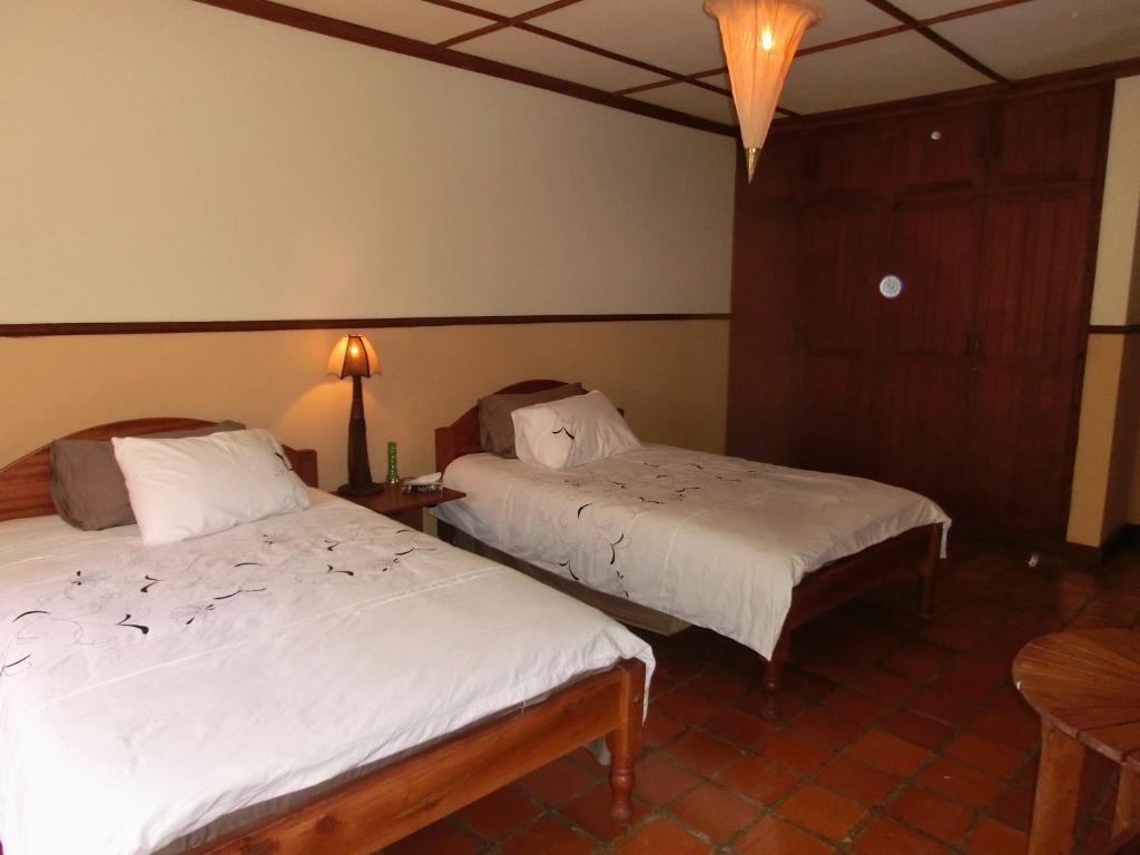 Postel nebo postele na pokoji v ubytování Mwanzo Lodge