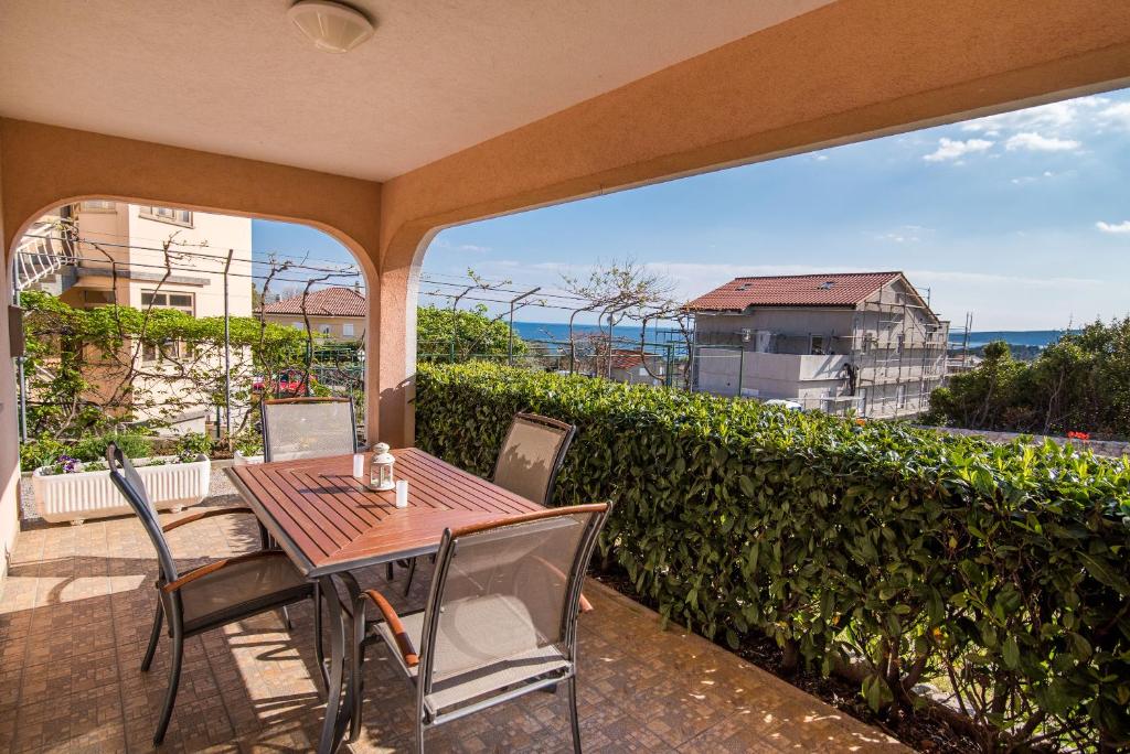 a table and chairs on a patio with a view of the ocean at Apartment Martina in Krk