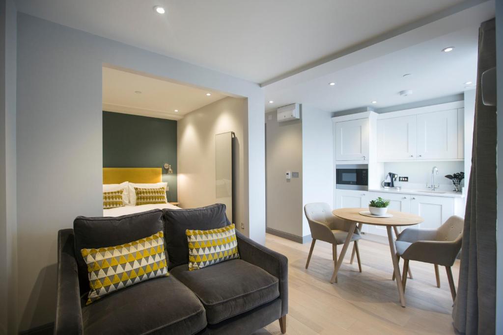 a bedroom and living room with a bed and a table at No.8 Waterloo Street in Birmingham