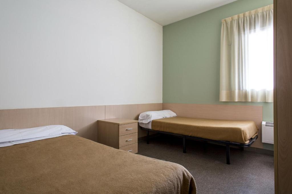 Postel nebo postele na pokoji v ubytování Residencia Universitaria Resa As Burgas