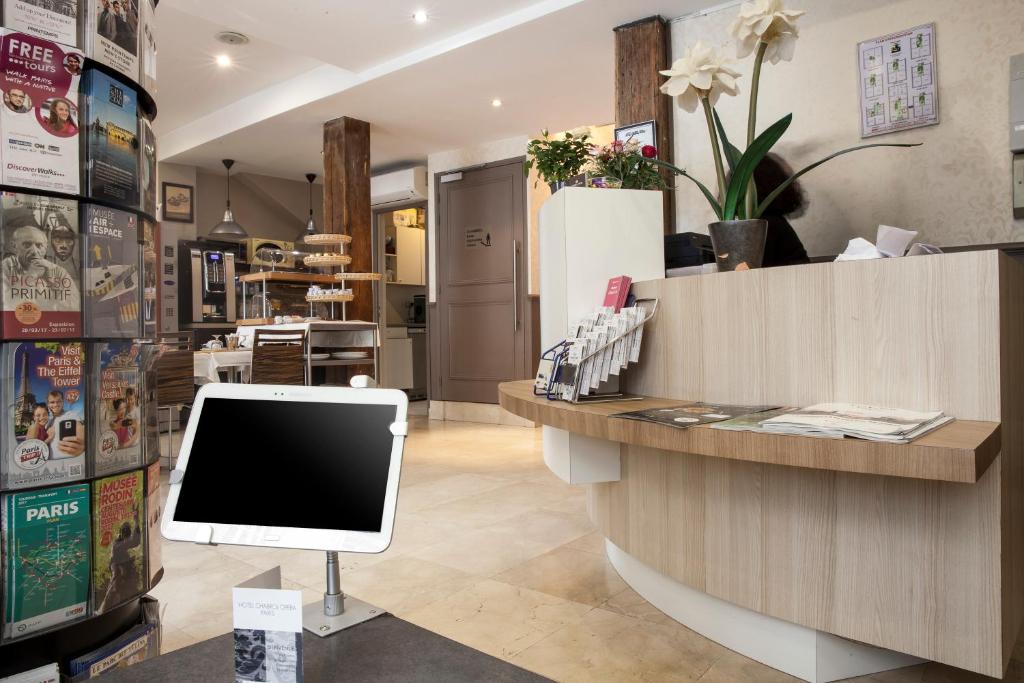 a store with a counter with a computer on it at Hotel Chabrol Opera in Paris