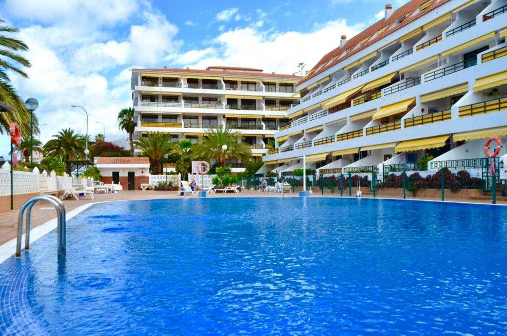 a large swimming pool in front of a building at Apartment Sunflower in Puerto de Santiago