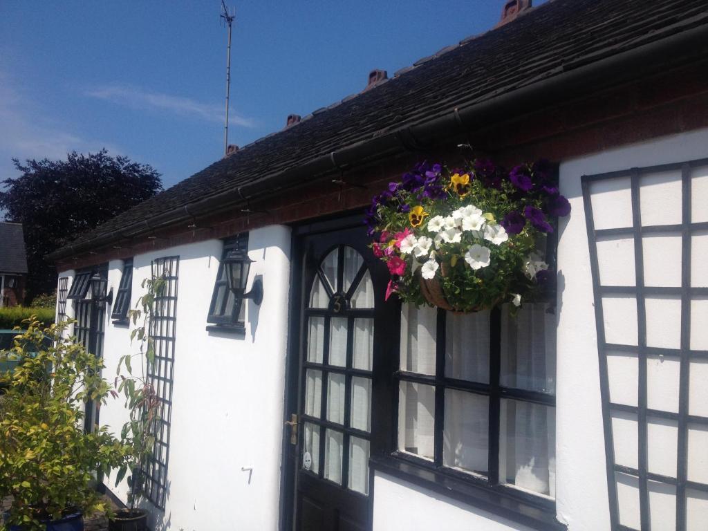 a house with a hanging basket of flowers on the door at The Green Man in Leek