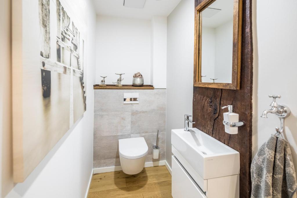 a bathroom with a white sink and a mirror at Gartenpalais 2 in Norderney