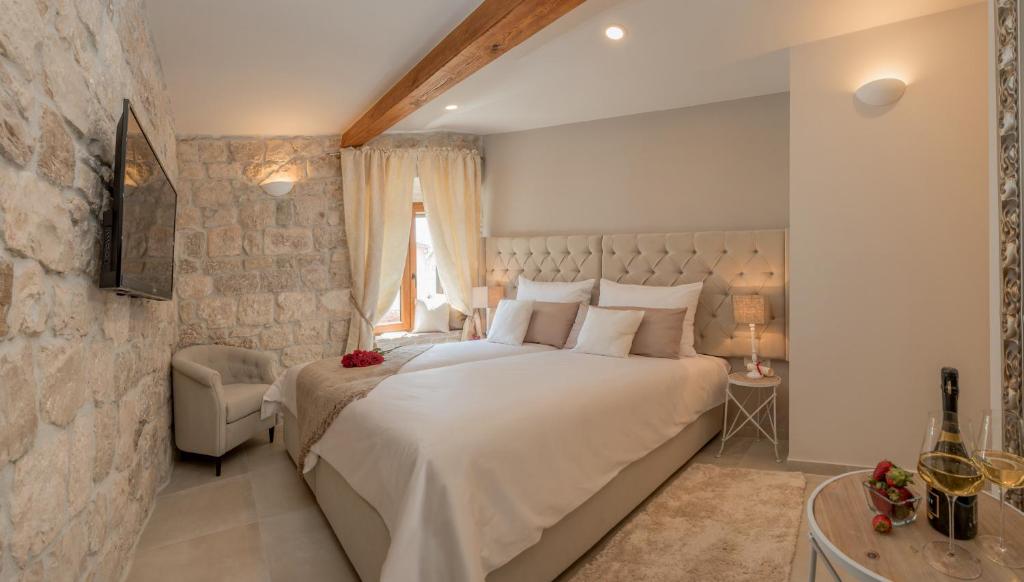 a bedroom with a large white bed and a window at Jupiter Lux Rooms in Split