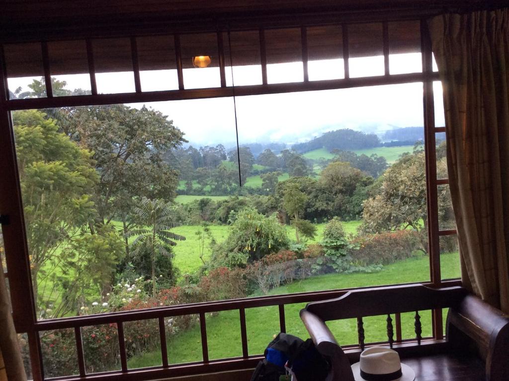 una ventana con vistas a un campo verde en Hacienda La Alegria, en Hacienda La Alegría