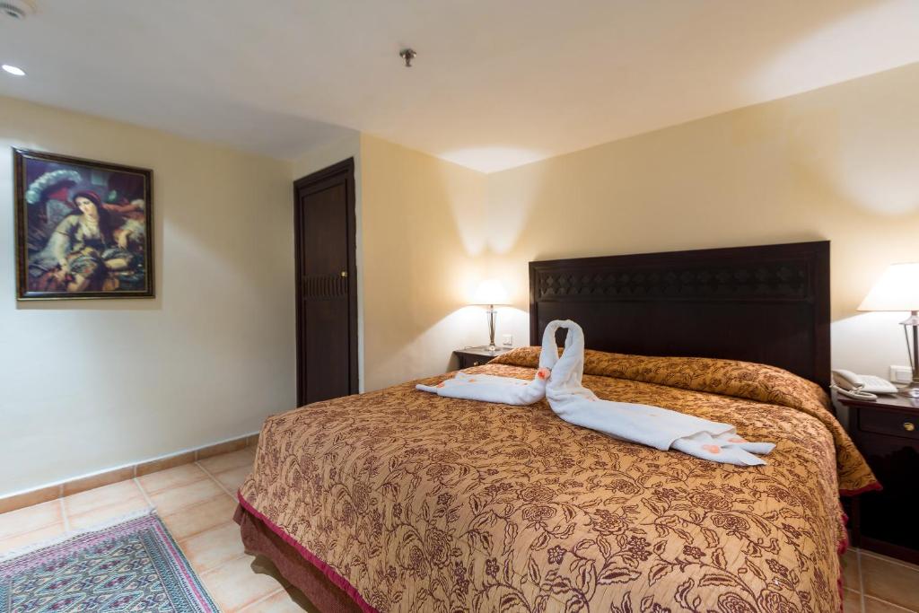 Postel nebo postele na pokoji v ubytování Kennedy Hospitality Resort