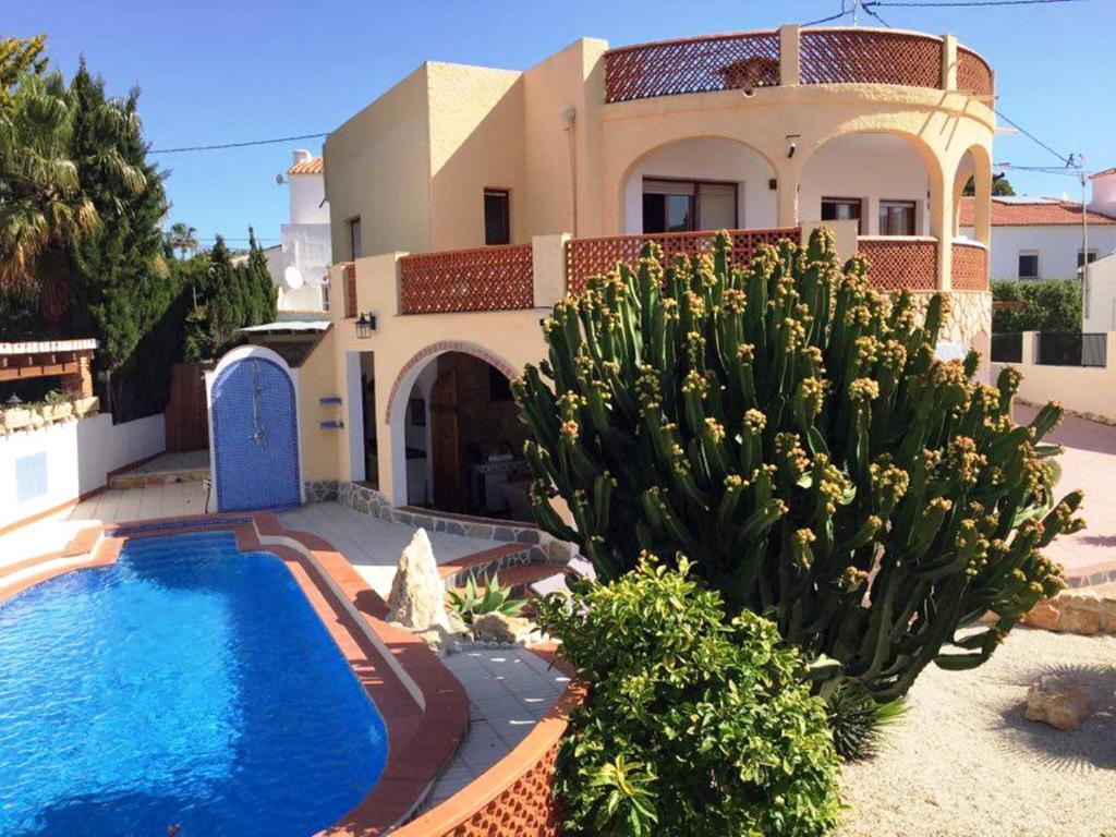 a house with a swimming pool in front of it at Villa Vid-Bil Calpe in Calpe