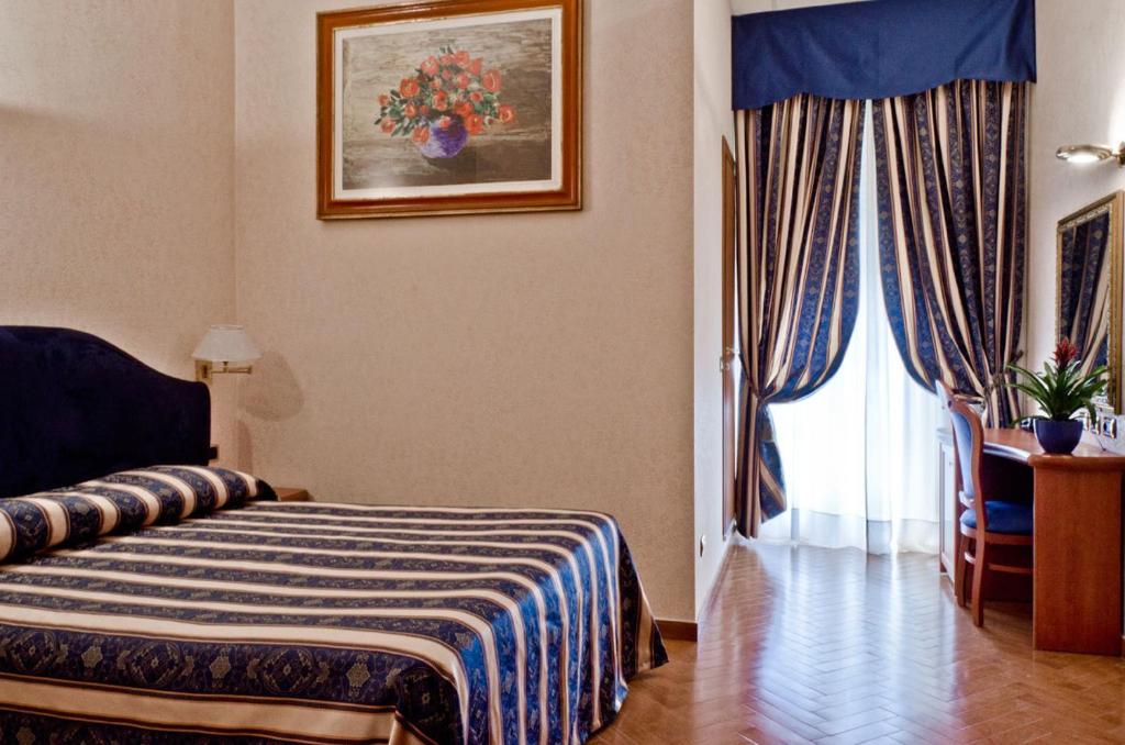 Postel nebo postele na pokoji v ubytování Hotel Brignole