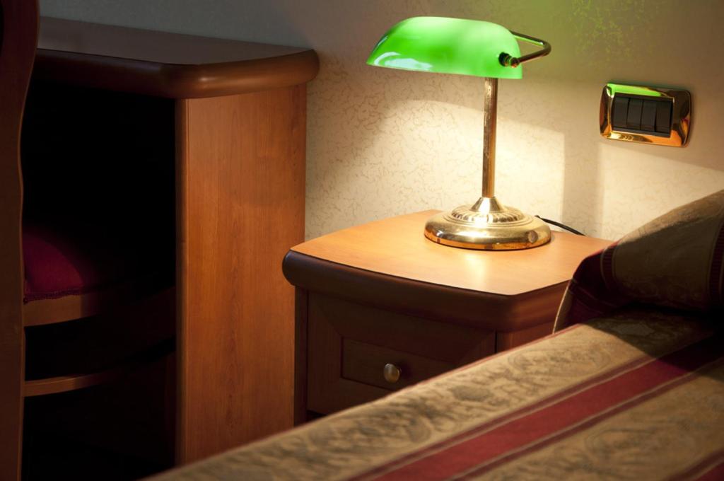 Postel nebo postele na pokoji v ubytování Hotel Brignole