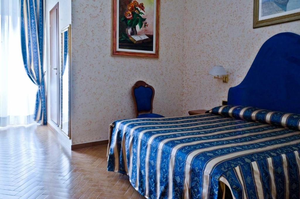 Postel nebo postele na pokoji v ubytování Hotel Brignole