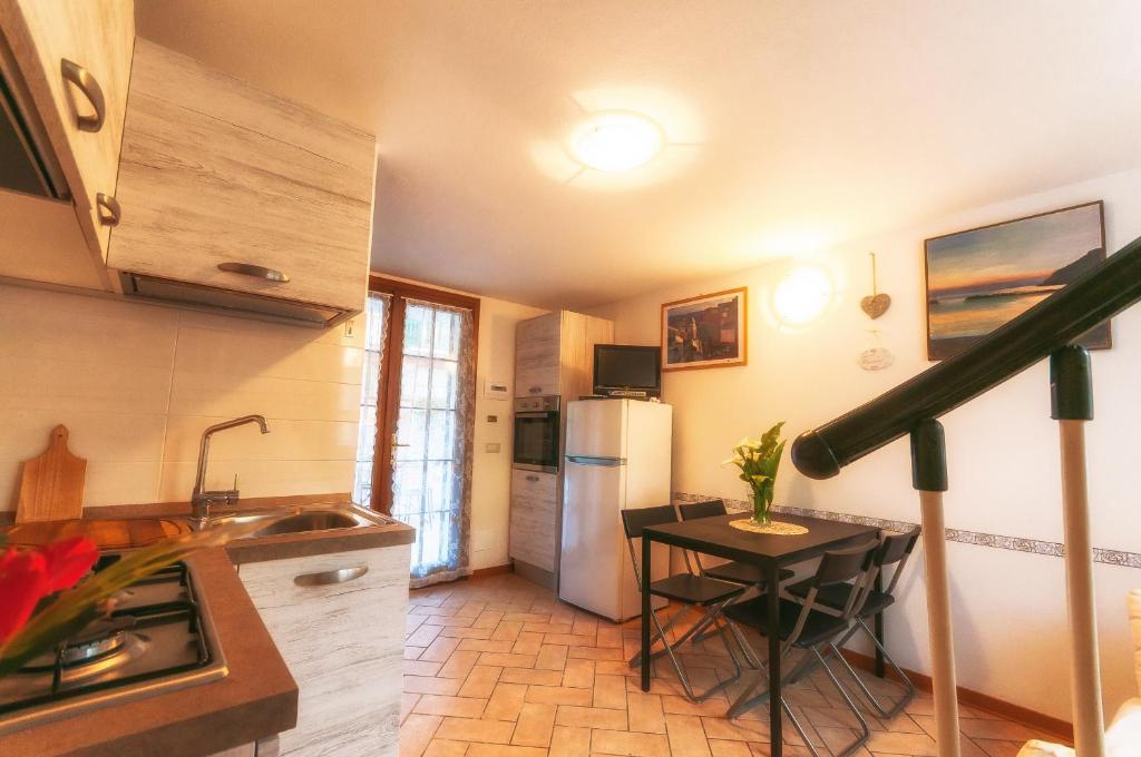 a kitchen with a small table and a refrigerator at Il Tiglio in Moneglia