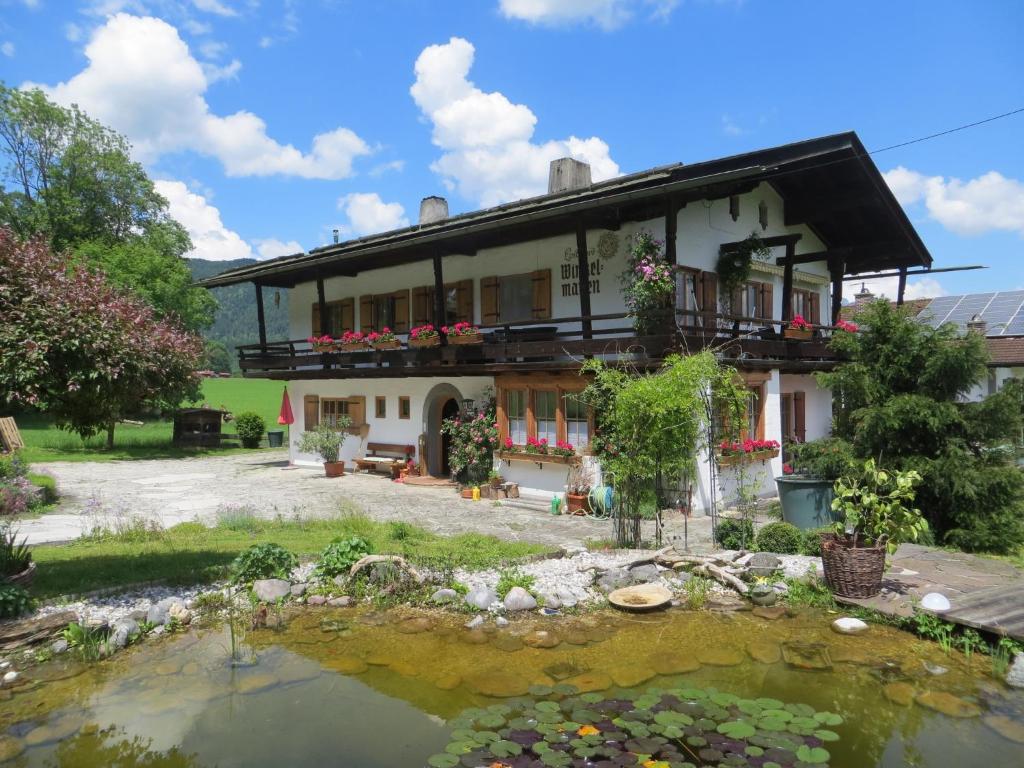 a house with a pond in front of it at Landhaus Winkelmatten in Schönau am Königssee