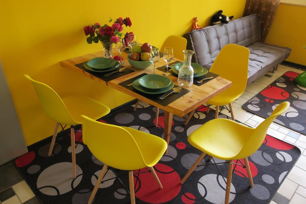 a dining room with a table and yellow chairs at Apartment Veseli in Split