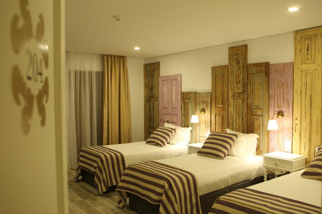 Cama ou camas em um quarto em Art'Otel Barcelos