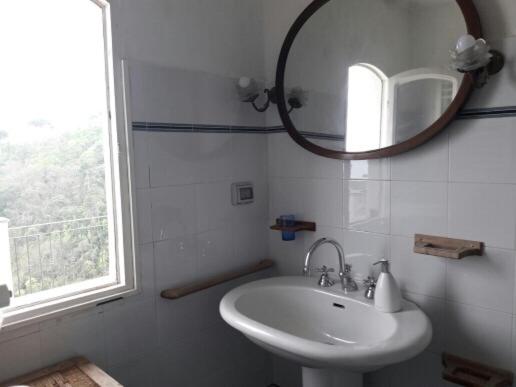 a white bathroom with a sink and a mirror at Trekking in paradise B&B in Santa Margherita Ligure
