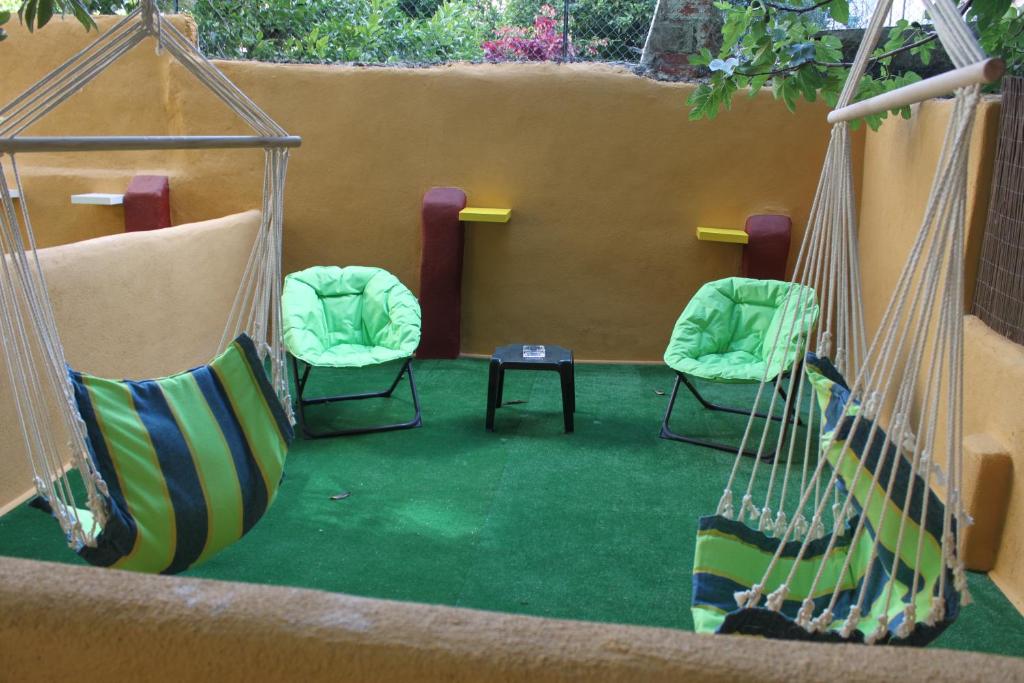リスボンにあるリスボン サンシャイン ホームズの緑のカーペットフロアの客室で、椅子2脚とテーブル1台が備わります。