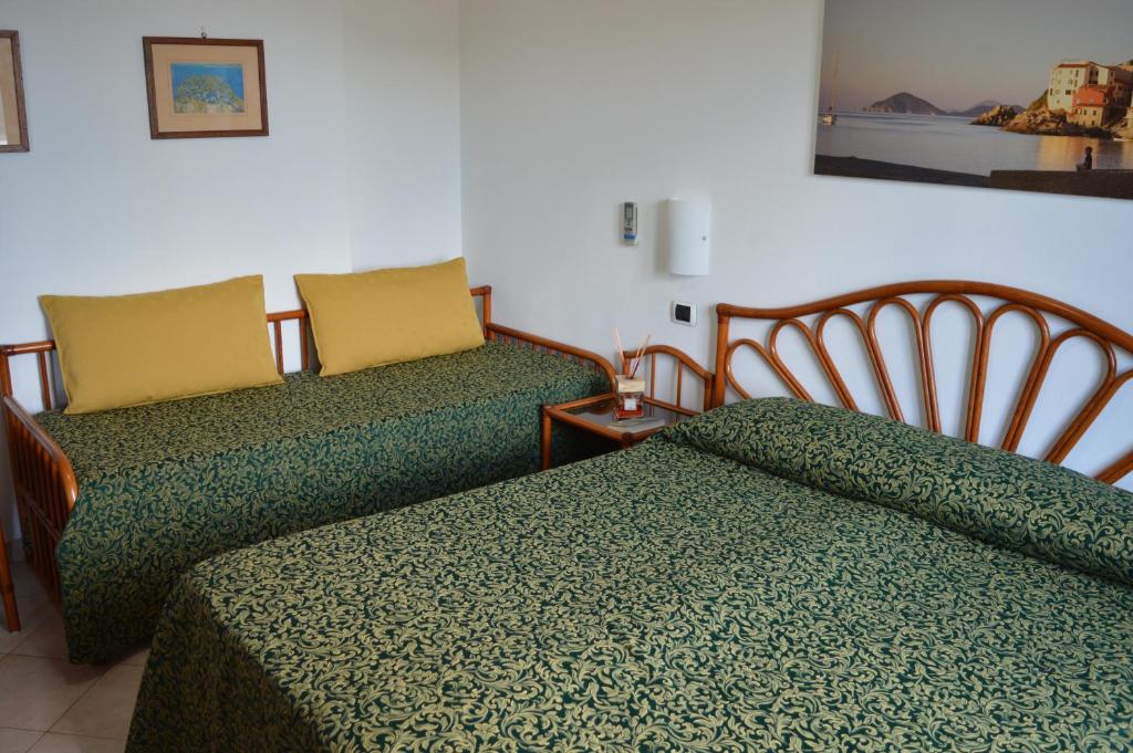 Postel nebo postele na pokoji v ubytování Albergo Le Briciole