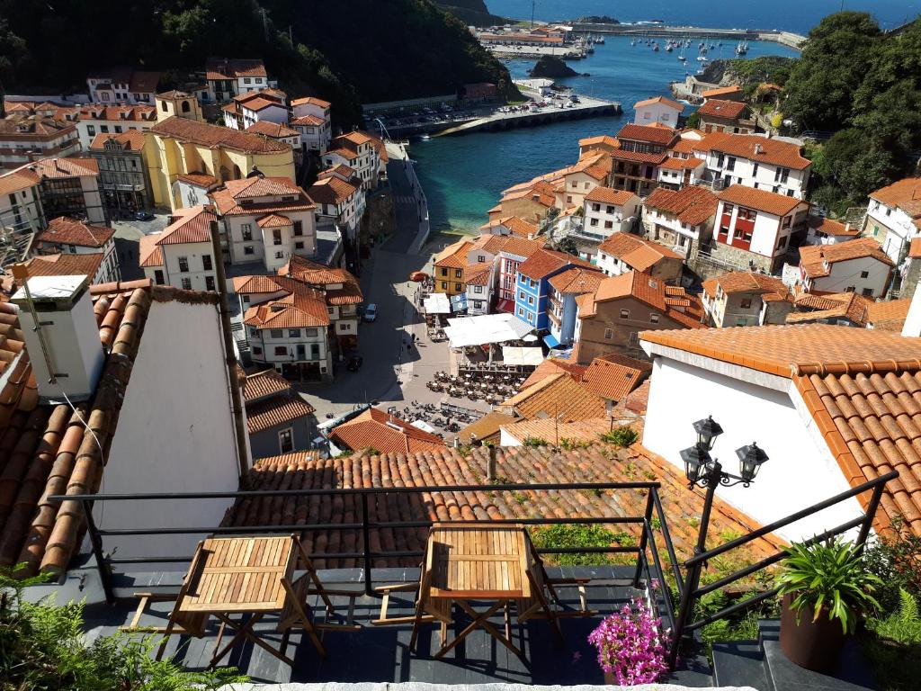 a view of a town with a river and buildings at Apartamentos La Casa del Pintor in Cudillero