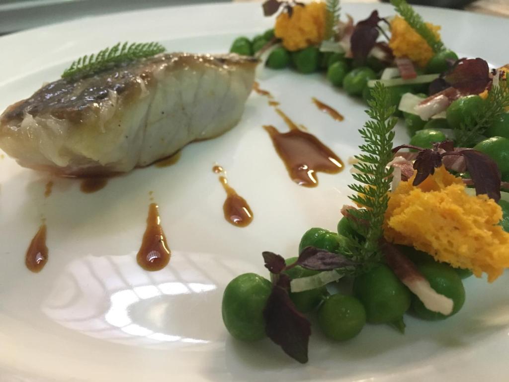 a plate of food with a piece of fish and vegetables at Thalacap Île de Ré - Thalasso & Spa in Ars-en-Ré