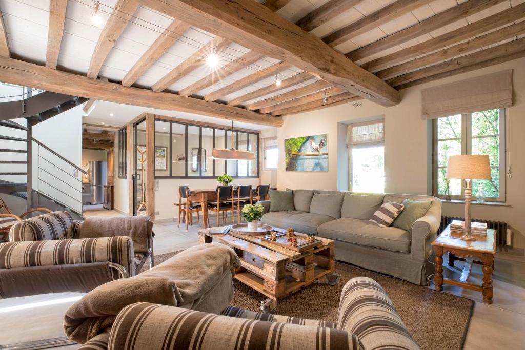 a living room with couches and a table at Le Clos du Verger in Levernois