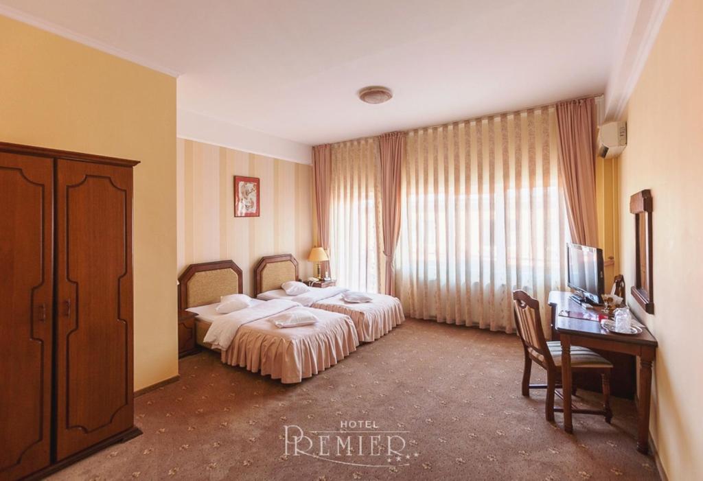 Postel nebo postele na pokoji v ubytování Hotel Premier