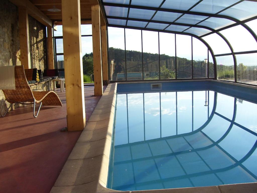 a swimming pool in a house with a glass ceiling at Il Sartù in Dogliani