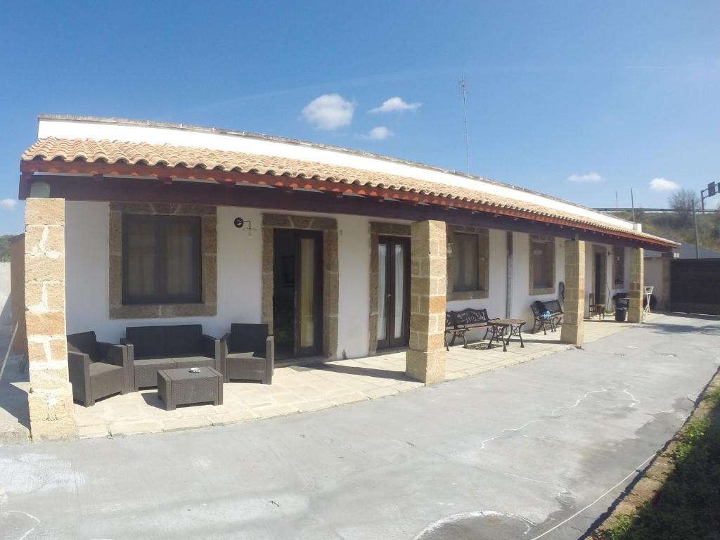 a building with a patio with furniture on it at Villa Patrizia in Taviano