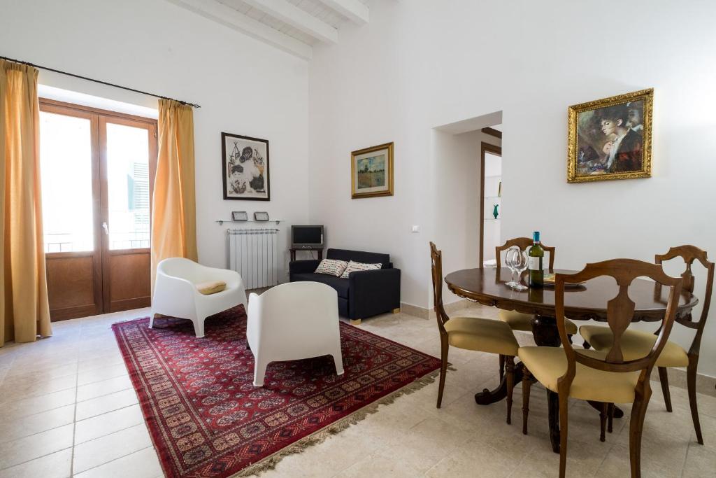 パレルモにあるSant'Agostino Apartment by DomuSicilyのリビングルーム(テーブル、椅子、ソファ付)