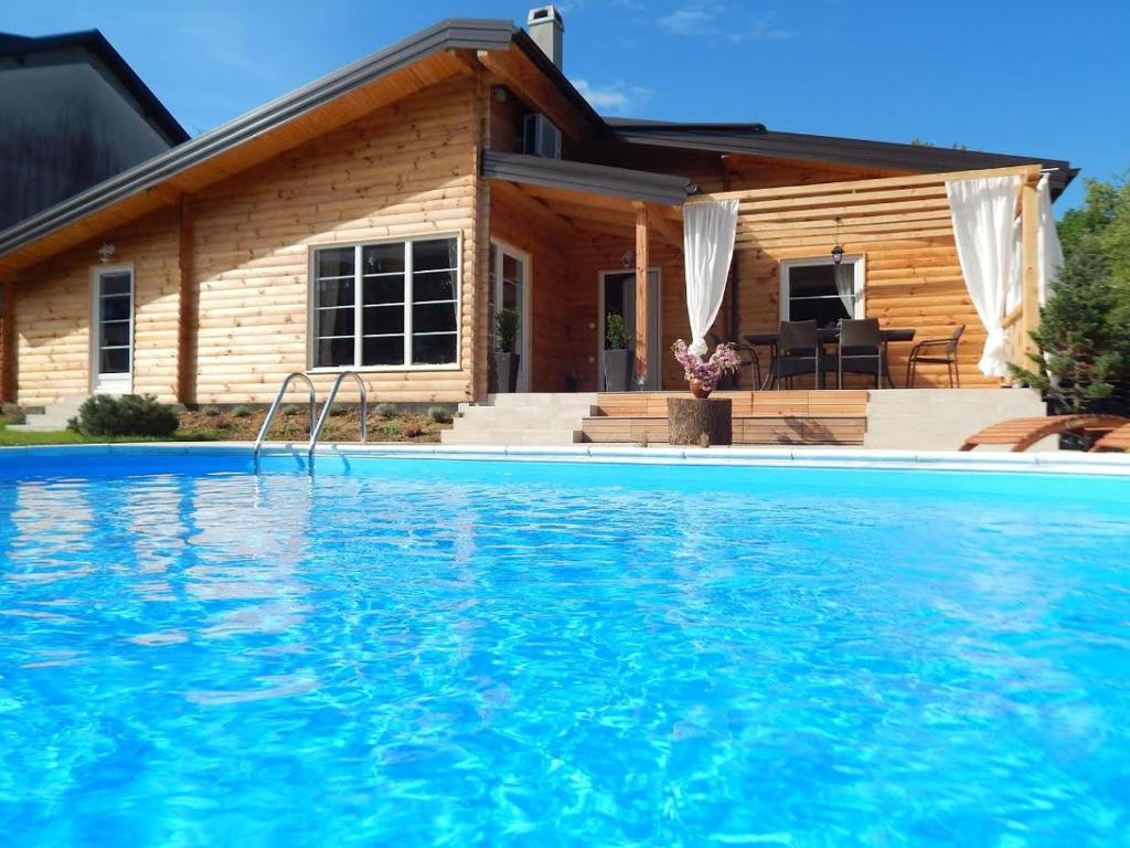 a house with a swimming pool in front of a house at Laganini in Samobor