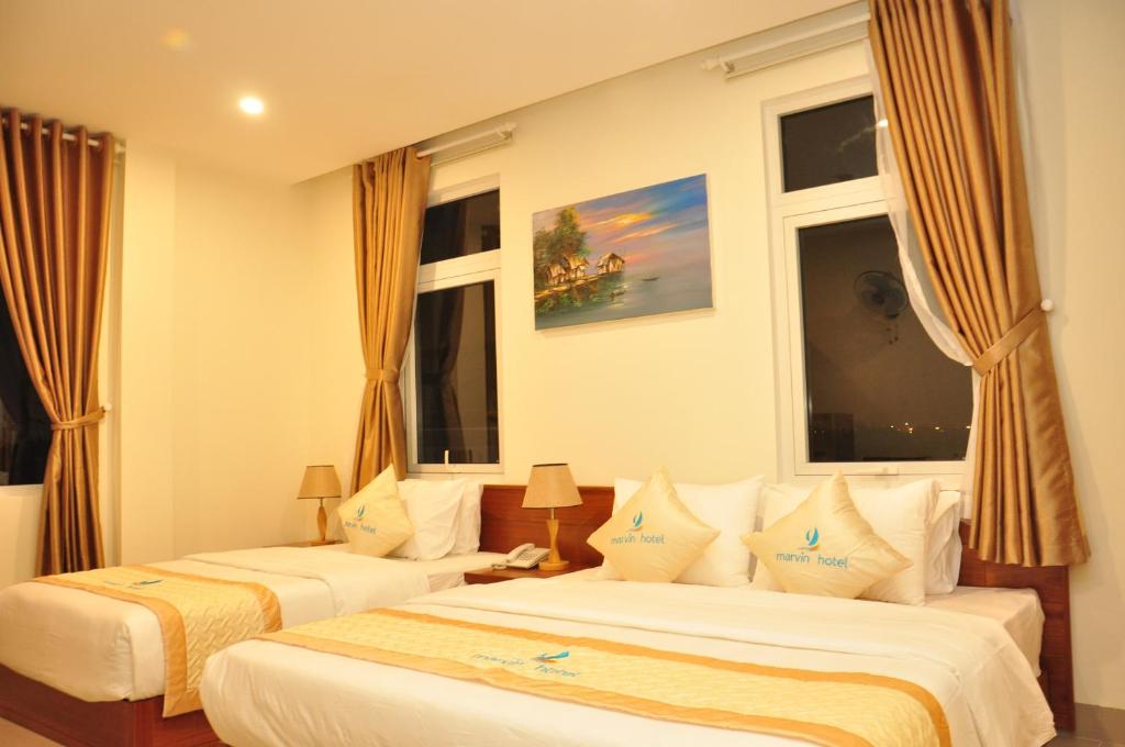 Giường trong phòng chung tại Marvin Hotel & Apartment