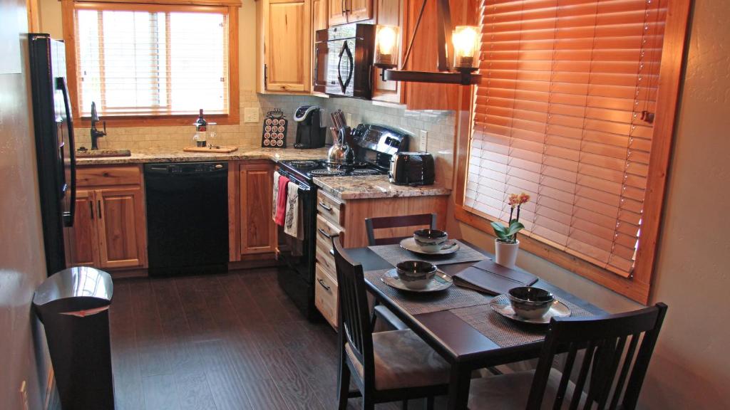 a small kitchen with a table and chairs in it at Cowboy Condo in Whitefish