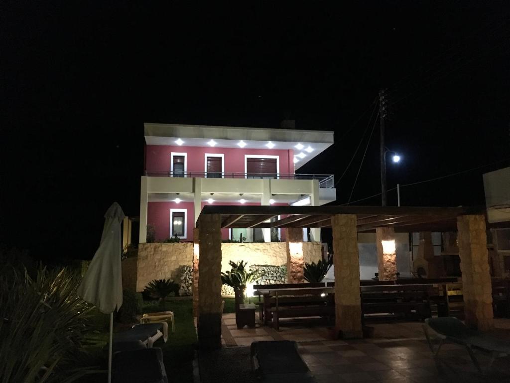 a house at night with lights on it at The Red Villa in Gennadi