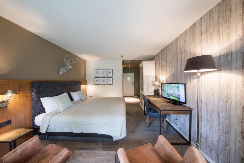 Postel nebo postele na pokoji v ubytování Bilderberg Hotel 't Speulderbos