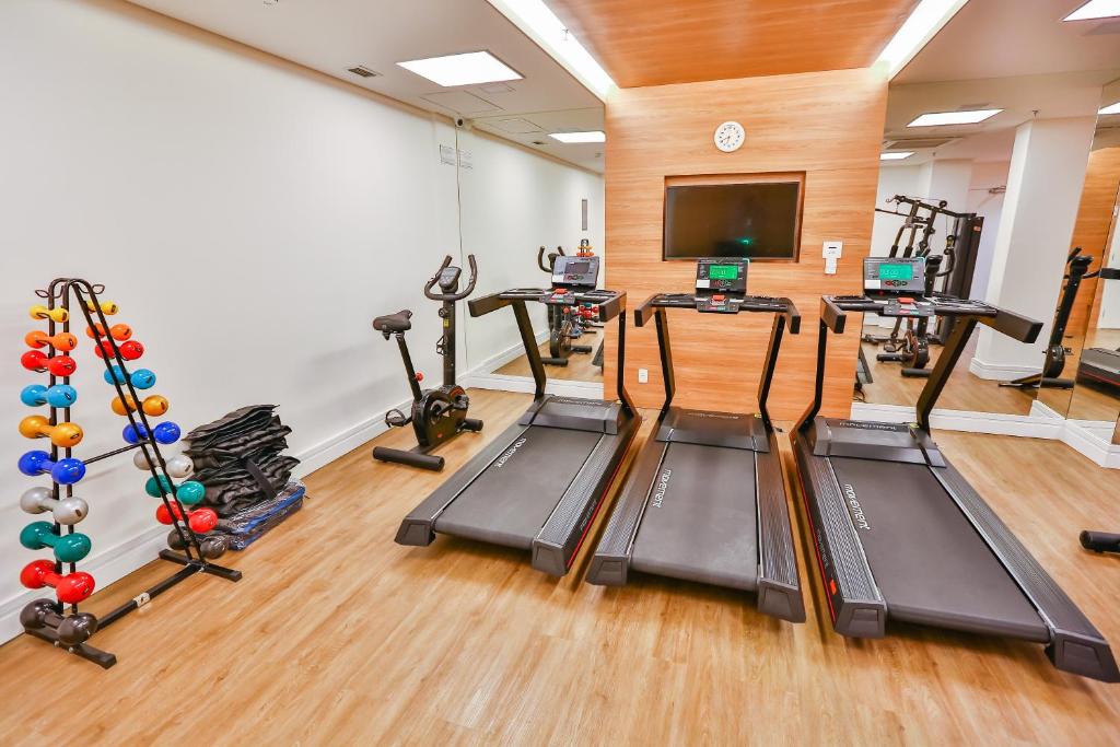 a fitness room with treadmills and exercise equipment at Sleep Inn Aeroporto de Guarulhos - São Paulo in Guarulhos