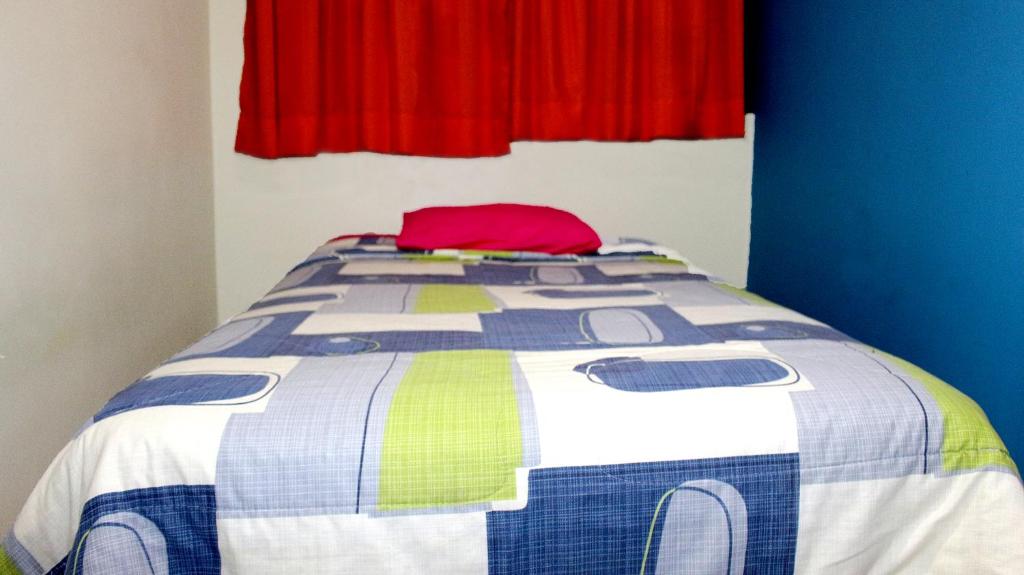Postel nebo postele na pokoji v ubytování Hostal Aventura