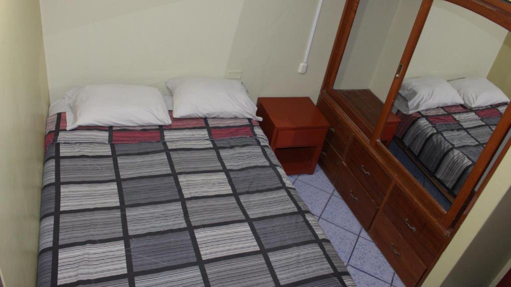 Postel nebo postele na pokoji v ubytování Hostal Aventura