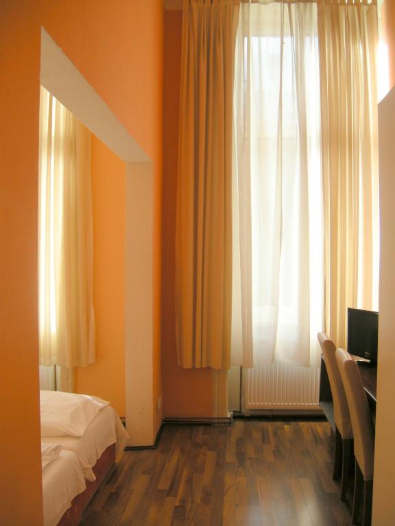 Un pat sau paturi într-o cameră la Pension Schottentor