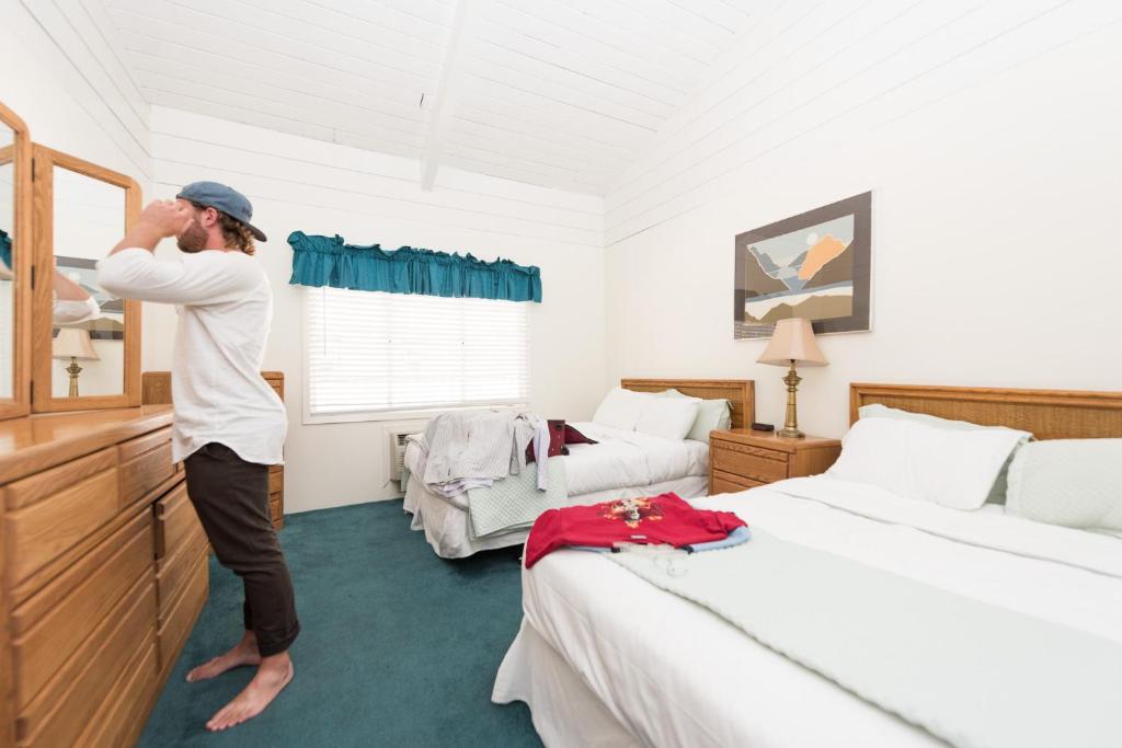 a man is standing in a bedroom at Bridge Bay at Shasta Lake in Shasta Lake