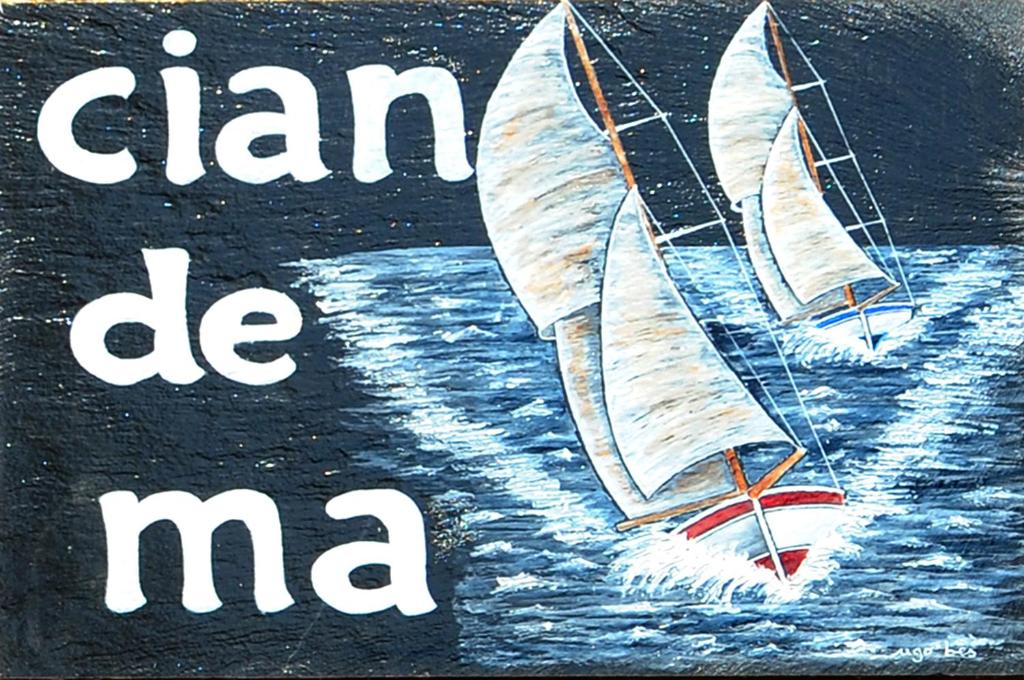 a painting of two sailboats on the water at Sivori Apartment in Bonassola