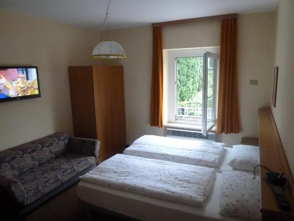 Postel nebo postele na pokoji v ubytování Garnì Ischia