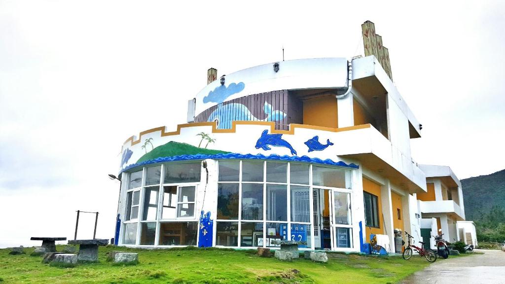 a building with animals painted on the side of it at White Sand Beach 32 in Green Island