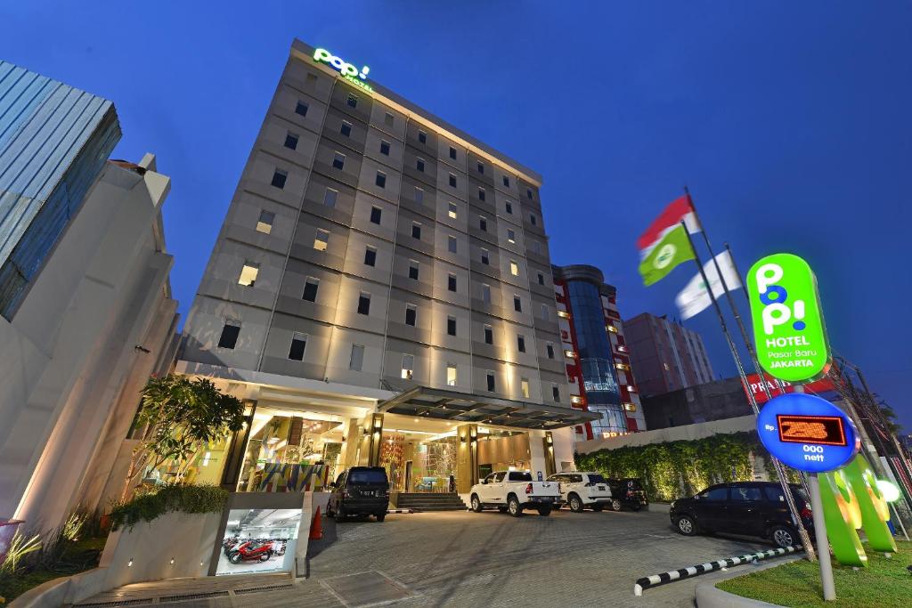 a hotel building with a sign in front of it at POP! Hotel Pasar Baru Jakarta in Jakarta