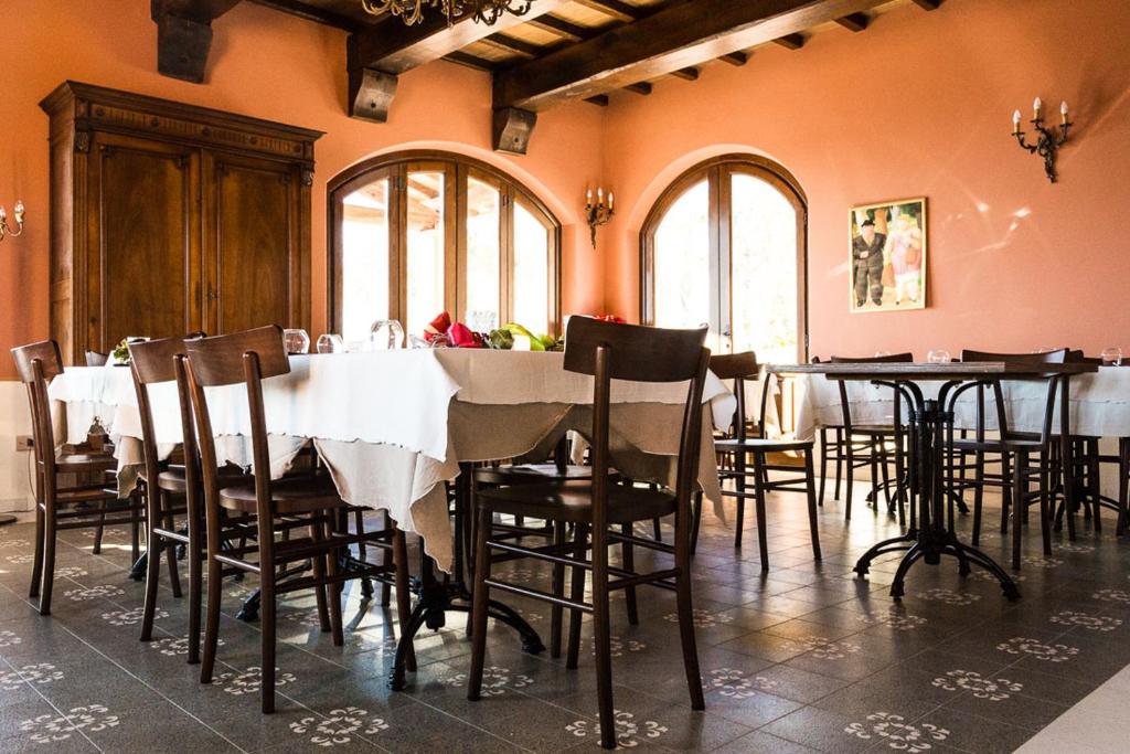 a dining room with tables and chairs and windows at De Vita Beata Agriturismo in Veroli