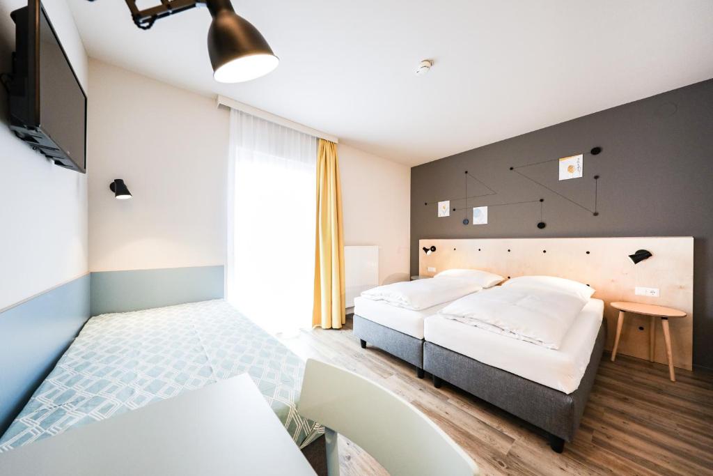 Posteľ alebo postele v izbe v ubytovaní Hotel Tullnerfeld